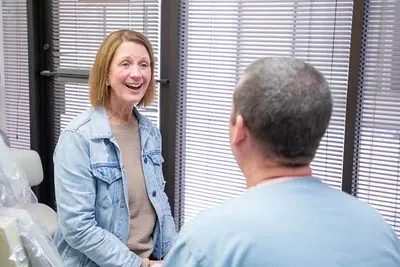 Dr. Alex Martin discussing dental care options with a new patient at his office